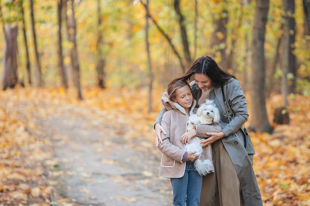Bambina con la mamma all'aperto nel parco al giorno d'autunno