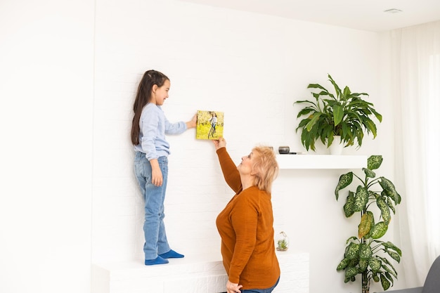 bambina e nonna con banner in mano, una tela fotografica.