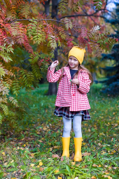 Bambina nel parco di autunno all'aperto