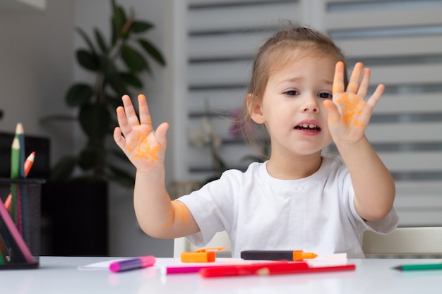 Bambina sveglia in una maglietta bianca di disegno