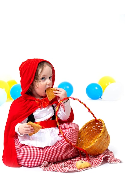 Bambina vestita come cappuccetto rosso su sfondo bianco Carnevale Purim Halloween