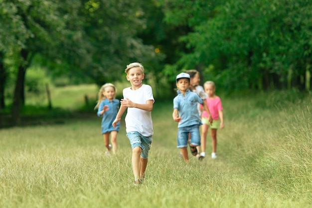 Bambini, bambini che corrono sul prato