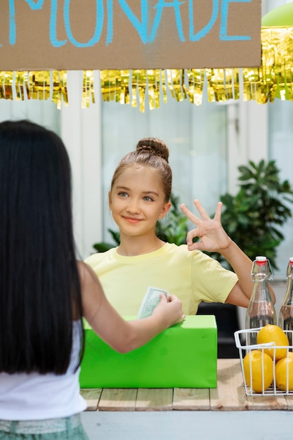 Bambini che organizzano un chiosco di limonate