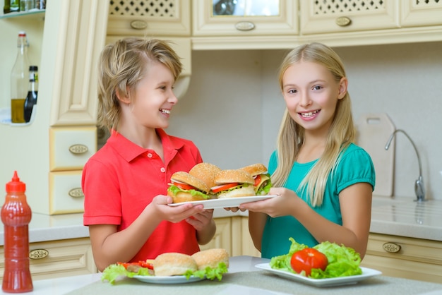 Bambini che preparano hamburger fatti in casa