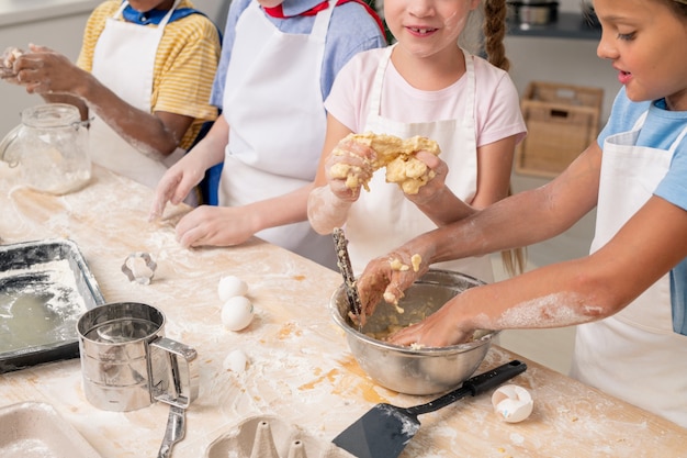 Bambini gioiosi che usano la tavoletta digitale per annotare le voci del menu per la festa di compleanno