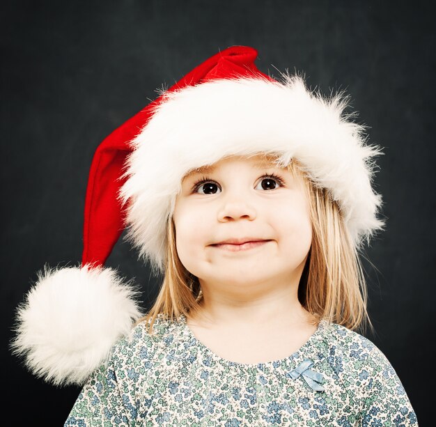 Bambino di Natale. Bambino felice con cappello da Babbo Natale sorridente