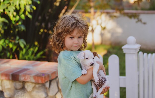 Bambino e cane che giocano al prato del cortile