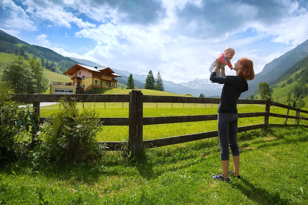 Bambino e madre con le montagne delle Alpi in natura sullo sfondo