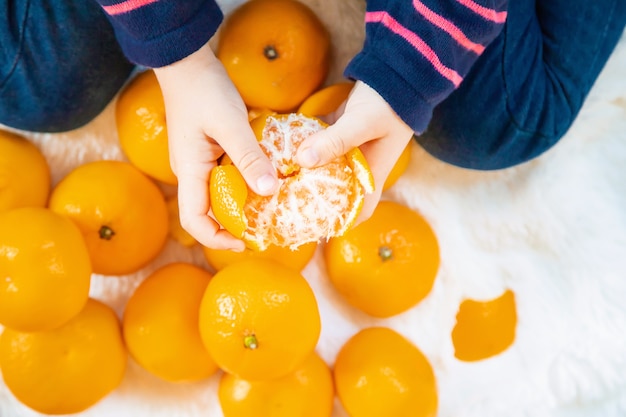 Bambino e mandarino. Messa a fuoco selettiva cibo e bevande.