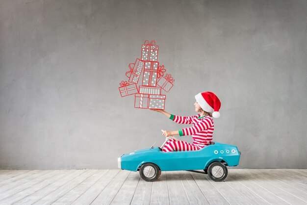 Bambino felice con il regalo di Natale. Bambino che si diverte a casa