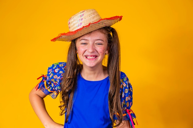 Bambino in abiti tipici della famosa festa brasiliana chiamata Festa Junina in occasione di Sao Joao Bella ragazza su sfondo giallo