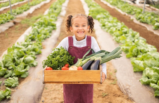 Bambino ragazza o contenitore di verdure in fattoria in agricoltura esportazione sostenibilità raccolto o natura ambiente successo Sorriso ritratto bambino felice e colture agricole piante a foglia verde o cibo salutare