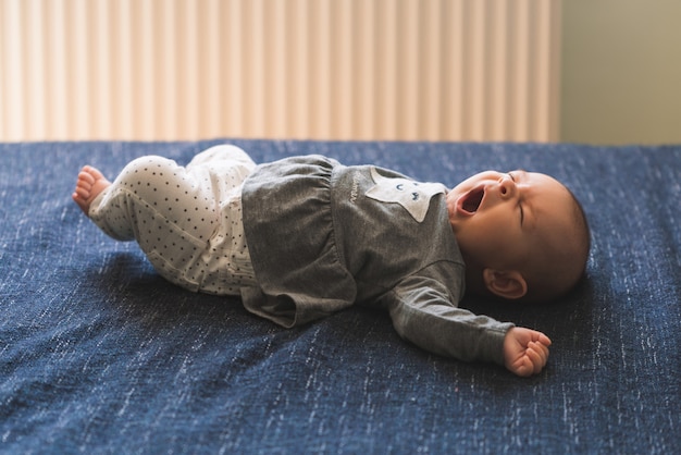 Bambino sul primo piano della coperta del fondo blu