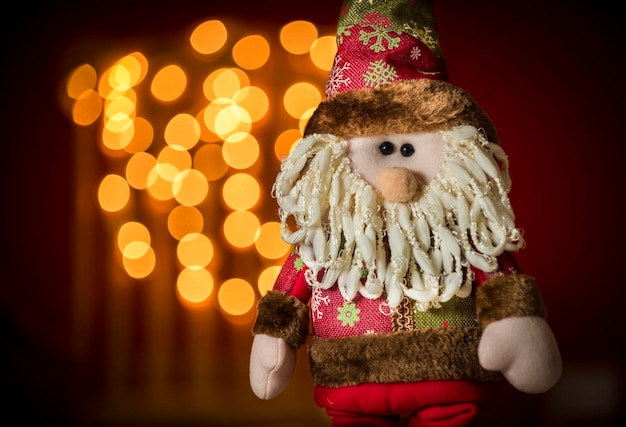 Bambola di Babbo Natale con le luci di Natale sullo sfondo