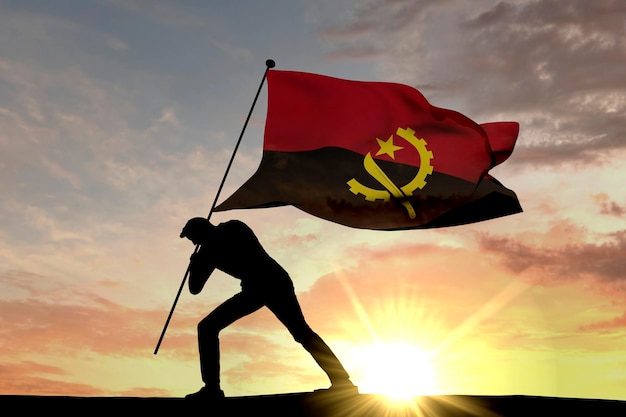 Bandiera dell'Angola spinta nel terreno da un rendering 3D di silhouette maschile