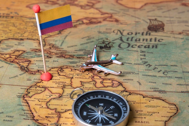 Bandiera della Colombia bussola e aereo sulla mappa del mondo