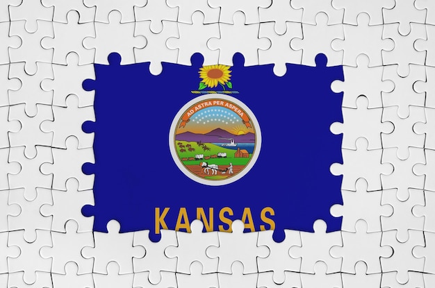 Bandiera dello stato americano del Kansas in cornice di pezzi di puzzle bianchi con parte centrale mancante