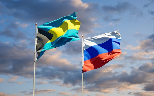 Bandiere di stato nazionali belle della Russia e Bahamas insieme sul cielo blu. Grafica 3D