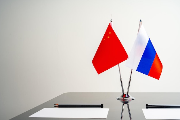 Bandiere russe e cinesi sul tavolo delle trattative