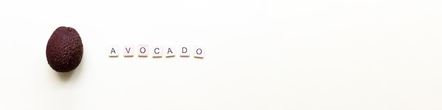 Banner Avocado piatto Parola avocado da lettere di legno Veganismo fruttarianismo
