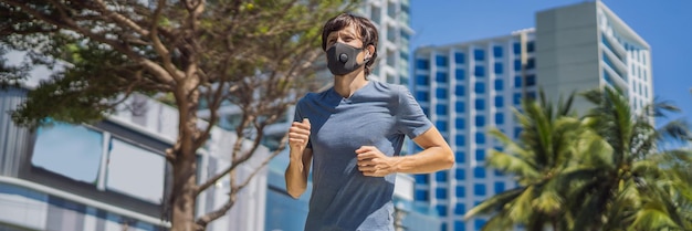 Banner lungo formato uomo corridore che indossa maschera medica che corre in città sullo sfondo del