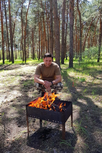 Barbecue crudo su spiedino di metallo nella foresta