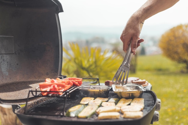 Barbecue vegetariano nel fine settimana Grigliare formaggio e verdure sulla griglia a gas all'aperto