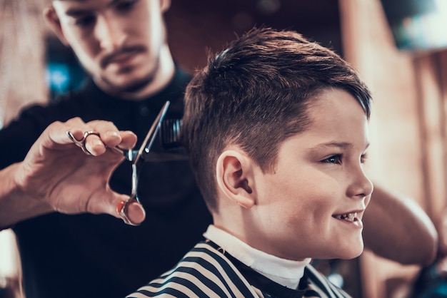 Barber Clips Handsome Kid Sides With Scissors