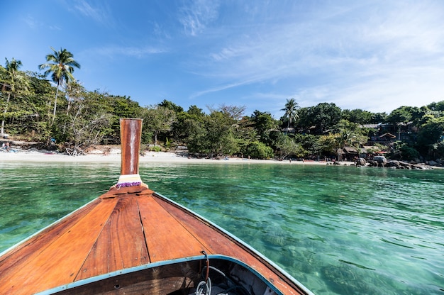 Barca a coda lunga in legno che naviga sul mare tropicale turchese all'isola di Lipe