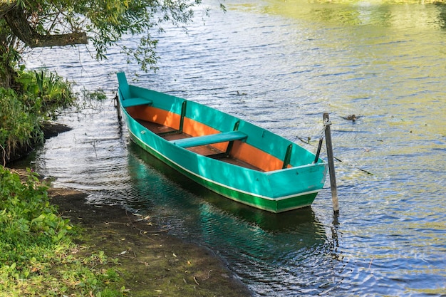 Barca a remi che galleggia sul lago per la pesca del lago all'inizio dell'estate