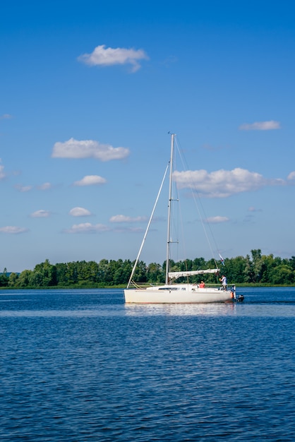 Barca a vela bianca sul fiume.