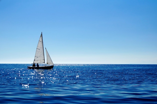 Barca a vela che naviga in mare contro un cielo limpido