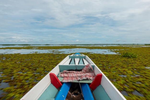 Barca da pesca in un lago d'acqua al mattinoVecchia barca da pesca in legno barca da pesca in legno in un lago d'acqua Bellissimo paesaggio vista natura a Talay noi Phatthalung Thailandia