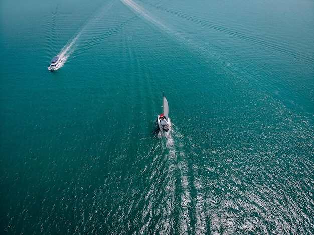 Barche a vela e barca ad alta velocità in mare aperto. Vista aerea - drone per barca a vela in condizioni ventose