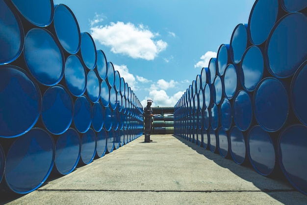 Barili di scorta di petrolio del tamburo di ispezione del lavoratore maschio blu