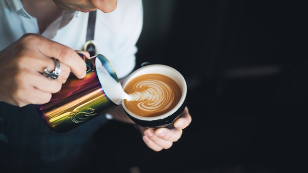 Barista che versa latte all&#39;arte del caffè del caffè espresso del caffè in caffè