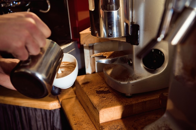 Barista del Latte del caffè che fa modello in una tazza di caffetteria.