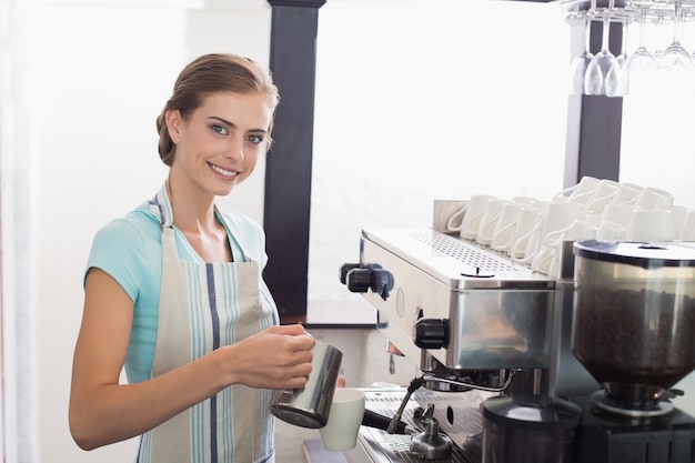Barista femminile che prepara caffè espresso alla caffetteria