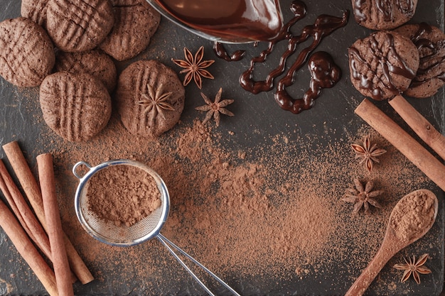 Barra di cioccolato e spezie rotte sul bordo di pietra