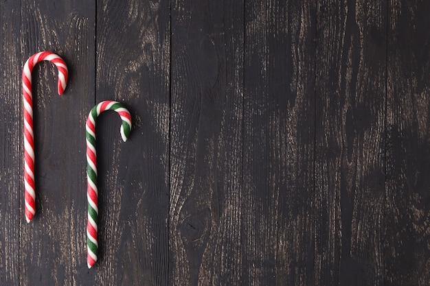 Bastoncini di zucchero sui bordi di legno - fondo di feste