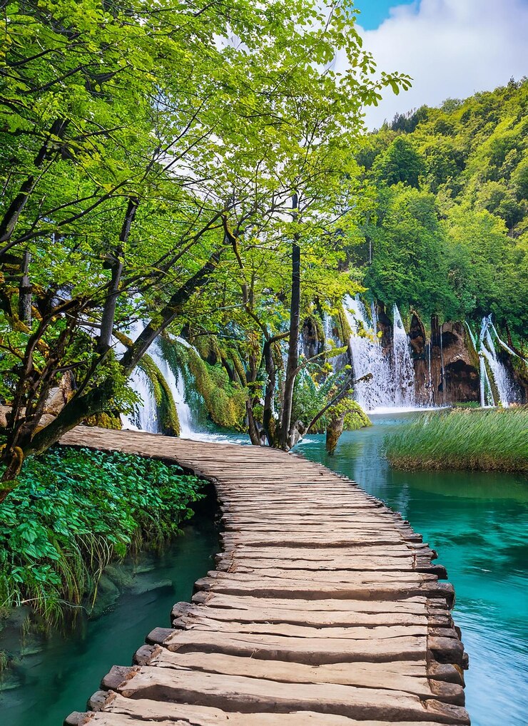 Beautiful wooden path trail for nature trekking with lakes and waterfall landscape_ai_generated