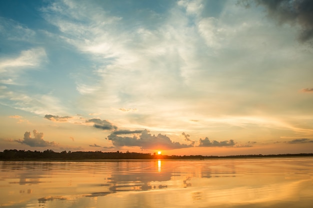 bel tramonto dietro le nuvole sopra lo sfondo del paesaggio del lago.