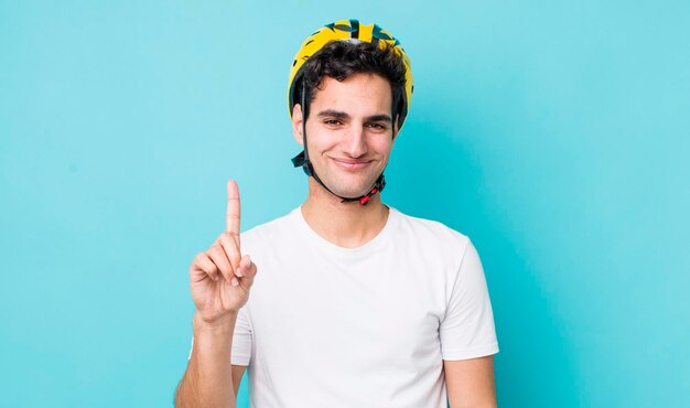 Bell'uomo ispanico sorridente e dall'aspetto amichevole che mostra il concetto di bici numero uno