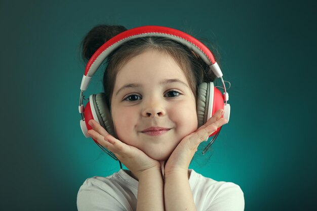 Bella bambina che ascolta la musica sul colore di sfondo