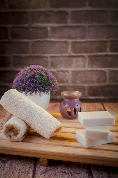 Bella composizione spa con saponi naturali con candele profumate e accessori per il bagno in un ambiente romantico per un concetto di pulizia C'è poca profondità di campo e spazio per il testo