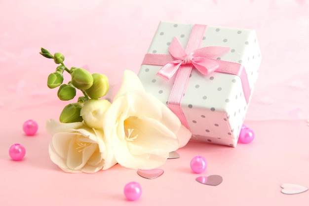Bella confezione regalo romantica e fiore su sfondo rosa