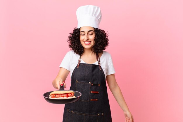 bella donna araba barbecue chef prepara hot dog