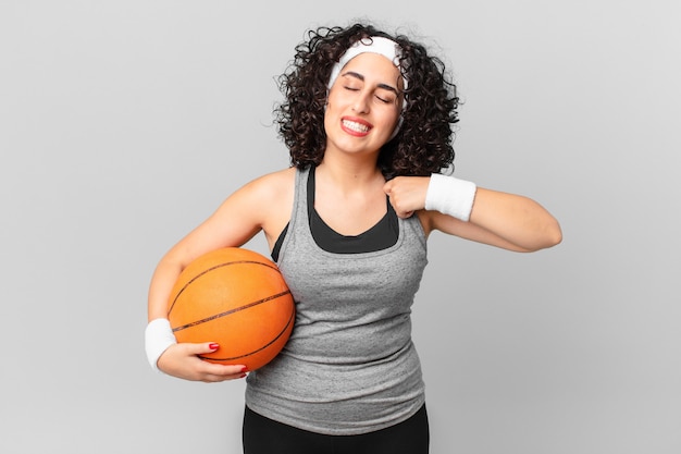 Bella donna araba che si sente stressata, ansiosa, stanca e frustrata e tiene in mano una palla da basket. concetto di sport