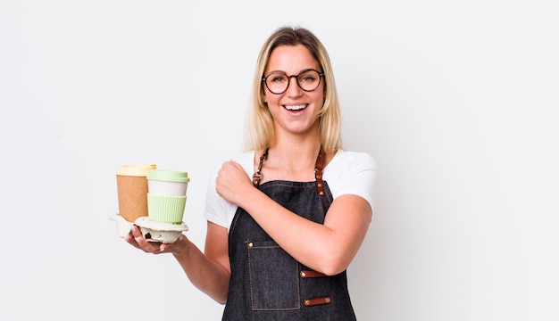 Bella donna bionda che si sente felice e affronta una sfida o celebra il concetto di caffè da asporto