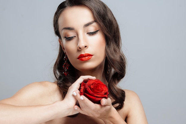 Bella donna bruna con rossetto rosso sulle labbra.